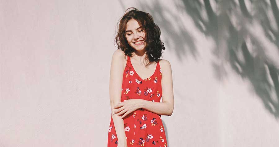 Girl in a red dress on plain background